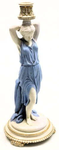 A late 19thC Royal Worcester glazed and bisque porcelain figural candlestick, modelled as a Roman woman, raised on a stepped circular base, and three scroll feet, impressed mark, 33cm high.