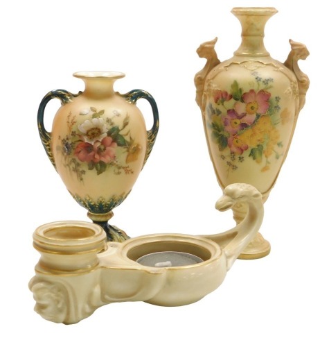 An early 20thC Royal Worcester blush porcelain Roman oil lamp formed candle holder, c1903, with a scrolling bird handle, and mask terminal, no.2268, printed marks, 14cm wide, a Royal Worcester blush porcelain vase, of twin handled baluster form, painted w