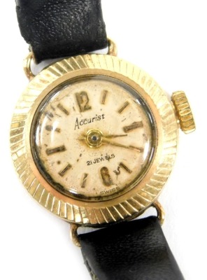 A mid century Accurist 9ct gold cased lady's circular wristwatch, champagne dial bearing Arabic numerals at 12 and 6, on a leather strap.