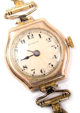 A mid century Rolex 9ct gold cased lady's wristwatch, circular dial with engine turned decoration, bearing Arabic numerals, on a plated bracelet strap.