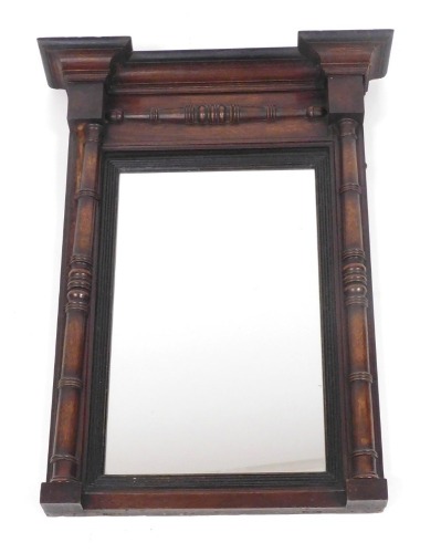 An early 19thC mahogany pier glass, with a break front pediment, above a rectangular glass plate flanked by turned pilasters, 73.5cm high, 54cm wide.