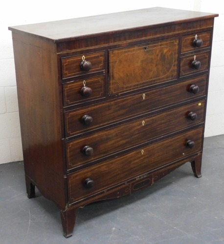 A mahogany and line inlaid secretaire chest, the central fall opening to reveal four drawers and six recesses, flanked by two short and one deep drawer, over three long graduated drawers, raised on splayed feet, 123cm high, 126cm wide, 56cm deep. Ivory li