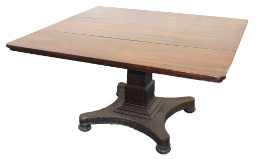 An early Victorian mahogany tilt top breakfast table, the rectangular top raised on a square stepped column over a quatrefoil base on bun feet, 71cm high, 130cm wide, 121cm deep.