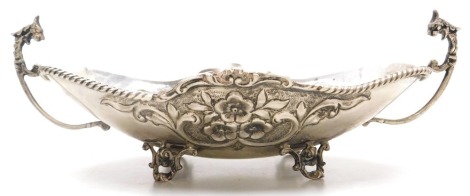 A Greek silver twin handled dish, of oval footed form, embossed with flowers, stamped 925, EPT.XEIPOC, 9.61oz.