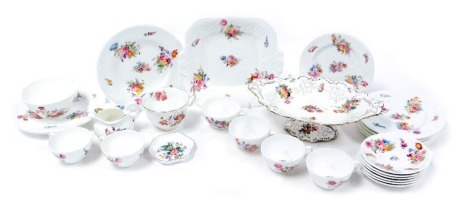 An early 20thC Coalport porcelain part tea service, moulded and decorated with floral sprays, comprising bread plate, three cake plates, cream jug, sugar bowl, six tea cups, saucers and tea plates, together with a breakfast cup decorated in the Junetime p