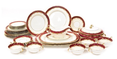 An Aynsley porcelain Rutland Burgundy pattern part dinner service, comprising pair of graduated meat platters, vegetable tureen and cover, sauce boat on stand, six dinner, dessert and side plates, six twin handled soup cups and saucers.