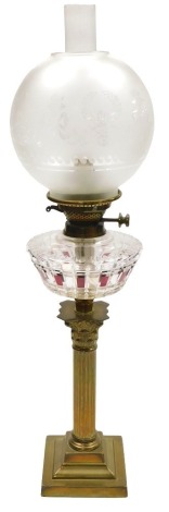 An early 20thC Hinks's Duplex glass oil lamp, of Corinthian column form, with a clear and red tinted cut glass reservoir, with chimney and an etched glass globular shade, 24cm high.