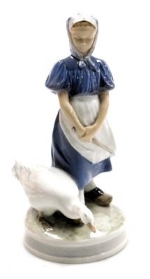 A Royal Copenhagen porcelain figure of a girl with a goose, no. 527, printed and painted marks, 24cm high.