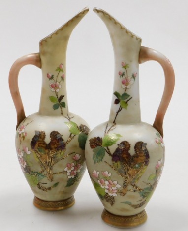 A pair of late 19thC Continental milk glass jugs, enamel decorated with birds and blossom, 32cm high.