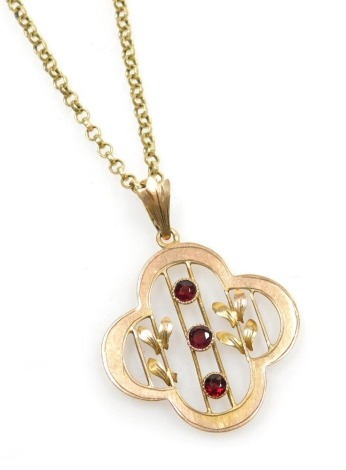 An Edwardian three stone garnet set floral pendant, in yellow and rose metal stamped 9ct, on a belcher link neck chain, stamped 9ct, 6.7g.