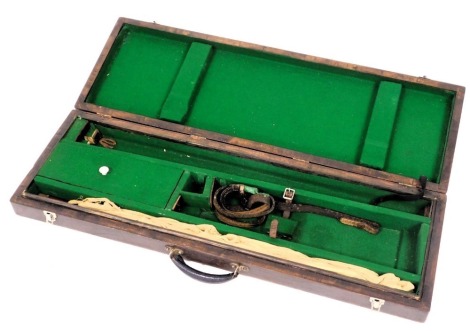 An early 20thC wooden gun case, with a fitted green baize interior, gun rods, etc., 90cm wide.