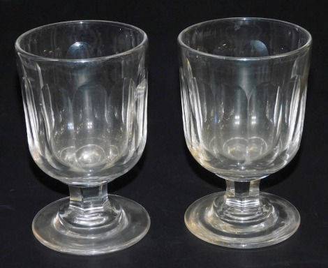 A pair of Victorian cut glass rummers, the oval vertical fluted bowl, raised on a hexagonal faceted stem, and outswept circular foot, with ground pontil, 15.5cm high.