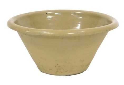 A Victorian pottery dairy bowl, with a light brown glaze, 44cm wide.