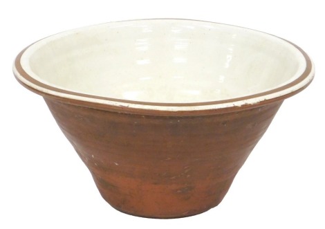 A Victorian terracotta and cream glazed dairy bowl, 41cm wide.