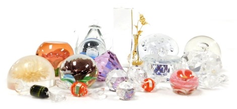 A group of glass paperweights and ornaments, including a teapot weight, pearl in a crystal oyster, intaglio sculpture of a rabbit, three glass candies, and two floral paperweights. (a quantity)