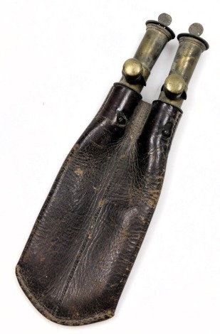 A 19thC brown leather and brass double powder flask, 24.5cm high.