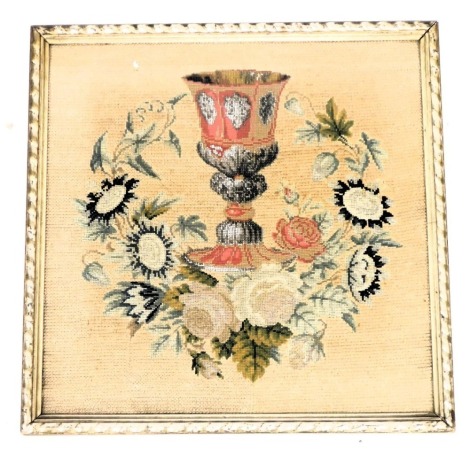 A Victorian beadwork and tapestry picture, of a chalice, within a wreath of roses and other flowers, framed and glazed, 46.5cm x 46.5cm.