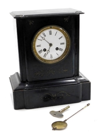 A Victorian slate mantel clock, the circular enamel dial bearing Roman numerals, eight day movement with bell strike, the case of engraved architectural form, with pendulum and key, 28cm high, 24cm wide.