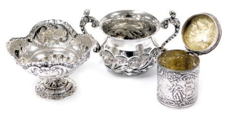 An Edward VII silver twin handled miniature cup, embossed with a band of thistles, London 1904, continental miniature tazza, of semi fluted footed form, embossed with fruit and rococo scroll framed shield reserves, white metal, bears foreign marks, and a