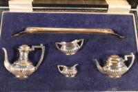 An Elizabeth II silver miniature tea set comprising of a tray and a four piece tea service