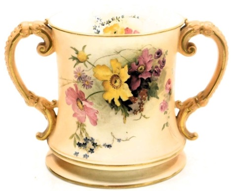 A Royal Worcester blush porcelain loving cup, c1918, painted with meadow flowers, printed and painted marks, 15cm high.