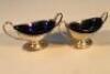 A pair of Edwardian silver salts of ovoid neo-classical form with blue glass liners