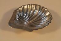 An Edwardian silver sweet meat dish in the form of a shell on three ball feet