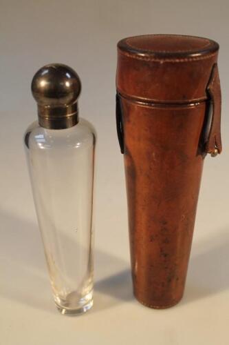 A late Victorian silver topped hunting flask in a leather case