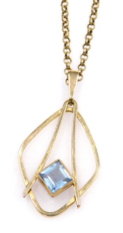 A modernist 9ct gold and pale blue gem set pendant, possibly a topaz, on a belcher link neck chain, with bolt ring clasp, stamped 9ct, 7.7g.