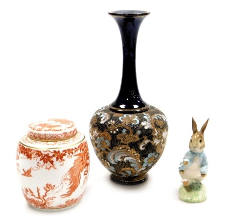 A Royal Crown Derby porcelain Red Aves pattern tea caddy and cover, printed marks, 11cm high, a Beswick Beatrix Potter figure of Peter Rabbit, and a Doulton Lambeth stoneware chine vase, of slender necked baluster form, decorated with flowers, impressed m