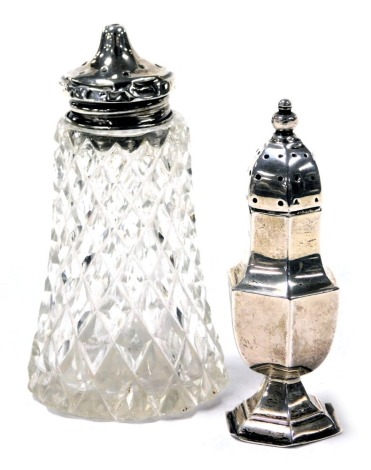 An Edward VII silver pepperette of hexagonal baluster form, Birmingham 1909, 0.43oz, together with a cut glass pepperette with silver lid, Birmingham 1921. (2)