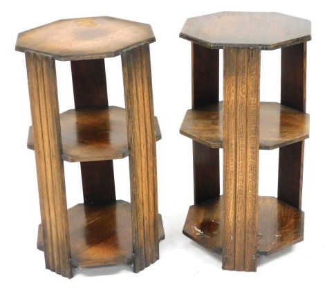 A pair of mid century oak two tier octagonal occasional tables, 69cm high, 37cm wide.