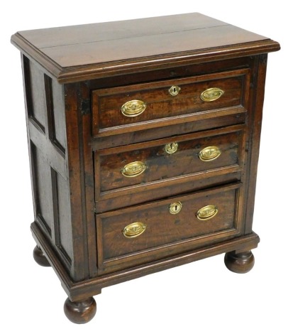 A Georgian and later oak chest, of three drawers, raised on bun feet, 92cm high, 78cm wide, 49.5cm deep.