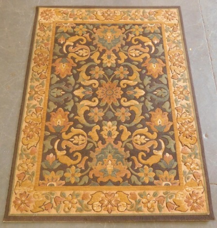 An Indian brown ground rug, decorated with flowers and foliate scrolls, within a repeating floral border, 231cm x 170cm.