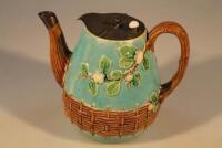 A late Victorian majolica teapot with pewter lid decorated in the Aesthetic movement style with impr