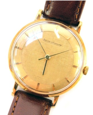 A Jaeger Le Coultre gentleman's 9ct gold cased wristwatch, the gold coloured circular dial bearing baton pointers, back case numbered 0547, on Darlena brown leather strap, case diameter 3.2cm.