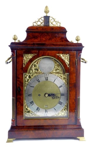 An 18thC mahogany cased bracket clock, with silvered Roman numeric dial, and Arabic minutes counters, date aperture, eight day movement, roundel bearing name for Pennington, Drury Lane., surrounded by raised scroll spandrels, the case surmounted by acorn