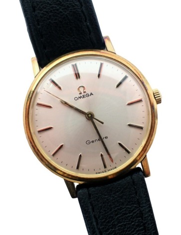 An Omega Geneva wristwatch, with a silvered watch face, an outer batoned border with seventeen jewel movement, in gold coloured plated outer case, 3cm diameter, on a black leather strap.