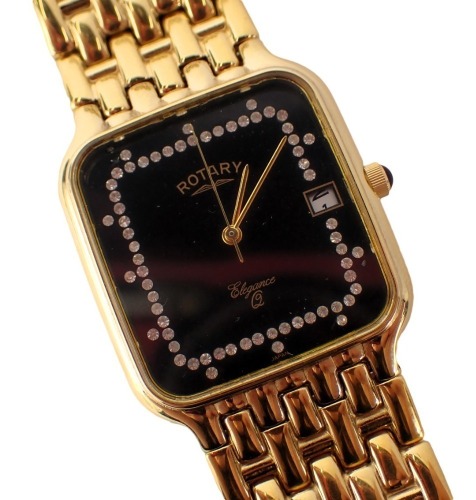 A Rotary Elegance wristwatch, with a black square set face set with crystals, with a date aperture, in gold coloured strap with stainless steel back, boxed.