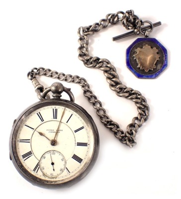 A Victorian silver cased pocket watch, with a white enamel Roman numeric dial, with gold hands and seconds dial, key wind, Chester 1891, on a white metal watch chain, unmarked, with a silver shield crest with blue enamelled design, 171g all in.