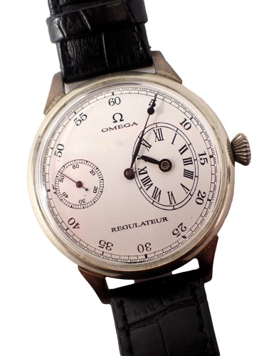 An Omega Regulateur wristwatch, with main dial, subsidiary dial and seconds dial, in stainless steel casing with a white enamelled face, the dial 4cm diameter, on a black leather strap, movement numbered 6858469.