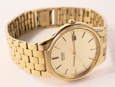 A Seiko gent's wristwatch, with a gold finish dial and date aperture, with gold coloured finish bracelet, on a stainless steel back number 9N0679, the dial 3cm diameter, with additional links, boxed. - 4