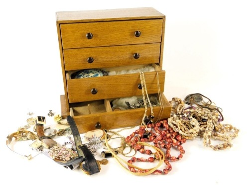 An oak four drawer jewellery box and contents, comprising Pulsar, Timex and Roamer ladies watches, a pair of 9ct cufflinks, 1.5g (AF), etc.