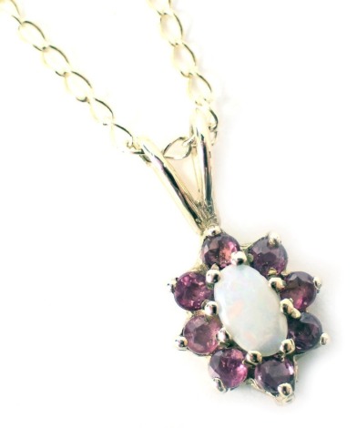 A 9ct gold pendant and chain, the floral cluster pendant set with opal and garnet, on a fine link neck chain, the pendant 1.5cm high, the chain 42cm long, 1.8g, boxed.