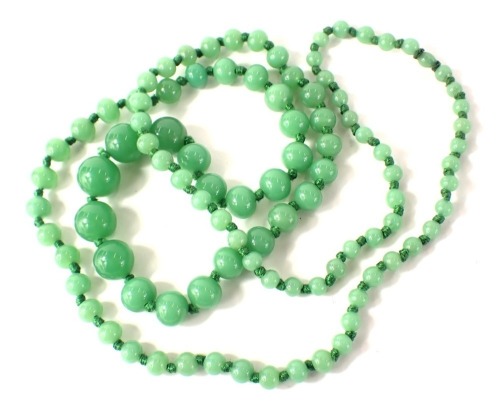 A jadeite graduated beaded necklace, the largest bead 10mm wide, the smallest 2mm wide, on a knotted green string strand, 82cm long, 70.7g.