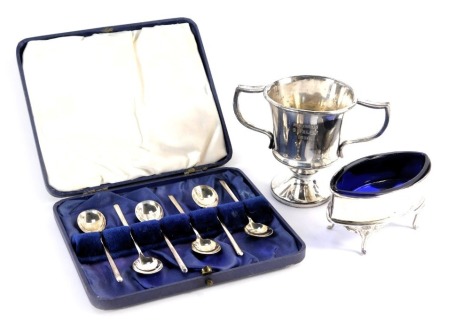 A set of six George V silver coffee spoons, of plain form with tapering handle, Sheffield 1932, 1.1oz, in fitted case, together with a Victorian open salt, with blue glass liner, and a plated trophy, bearing engraving 'One Hundred Yards E.Flack 1928'.