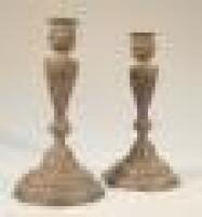 A pair of 19thC French rococo style cast metal candlesticks