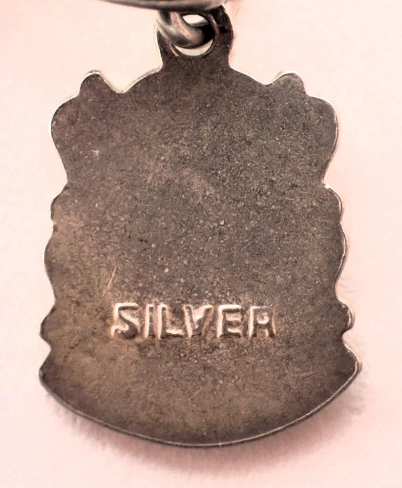 Two charm bracelets, comprising a white metal example with various