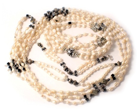 Four cultured pearl jewellery items, comprising two necklaces and two bracelets, each with black metallic finished square bead breaks. (4)