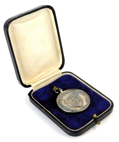 A 1930s silver football medal, for 47th (2nd London Division) Territorial Army, and inscribed London Scottish Football 1930-1931 Winners J K Bishop, hall marked Birmingham 1929, 0.47oz, in fitted case.